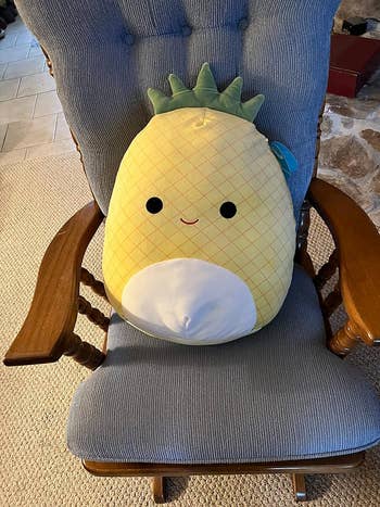 pineapple squishmallow on a chair