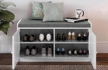Shoe retention  seat  with a cushioned seat, 2  signifier   pillows, a mug, and disposable   footwear stored inside