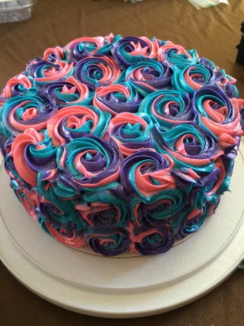 reviewer's cake with purple blue and red flower swirls