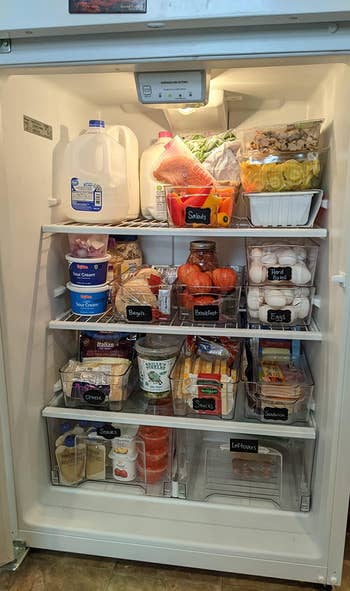 another reviewer's fridge organized using the bins, which they've labeled