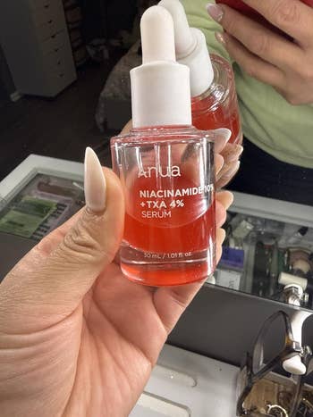 Person holding a serum vessel  labeled 