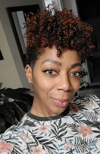 reviewer using the mousse on kinky curls, styled in an updo
