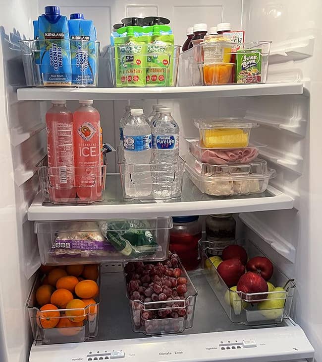 reviewer photo of their fridge contents organized with the clear bins