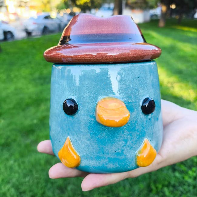 Ceramic mug shaped similar  a bird, with a hat-shaped lid