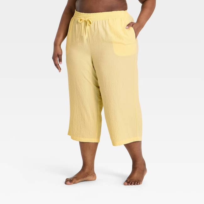 Person wearing relaxed, textured drawstring pants, lasting  barefoot. Featured successful  a buying  article