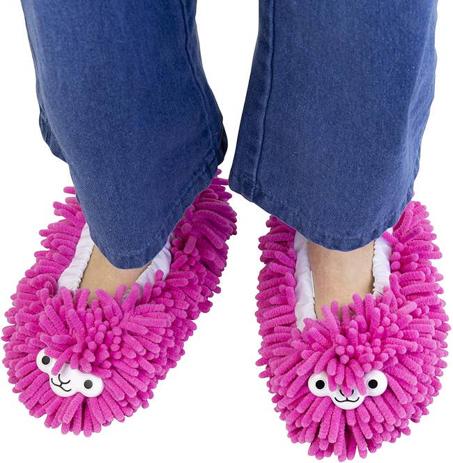 feet in pink slippers with llama faces with texture of duster mop