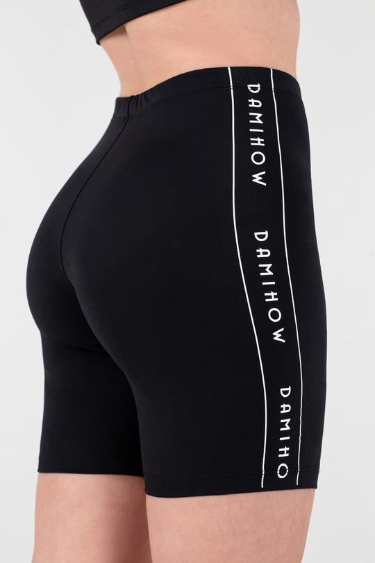 model wearing black biker shorts with