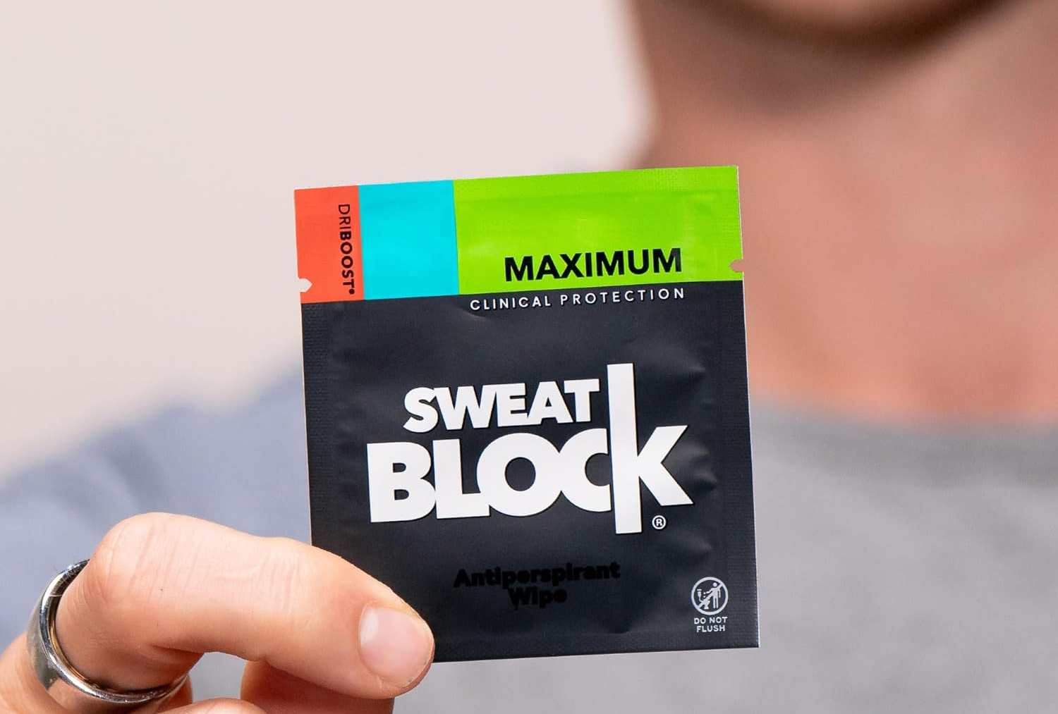 model holding a sweat block wipe