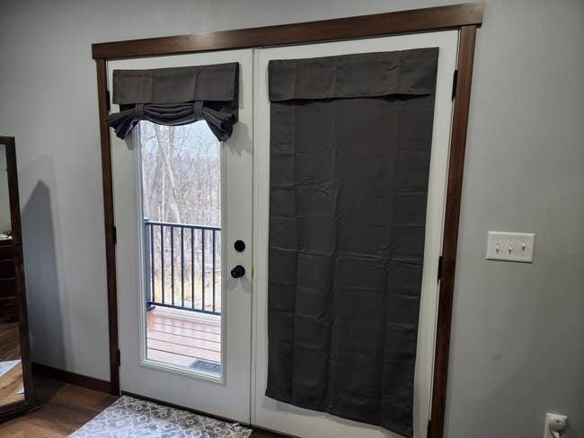 one glass door with cover completely down and another with the curtain up