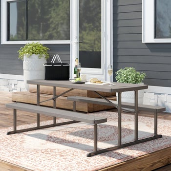 the taupe table and benches on an outdoor patio