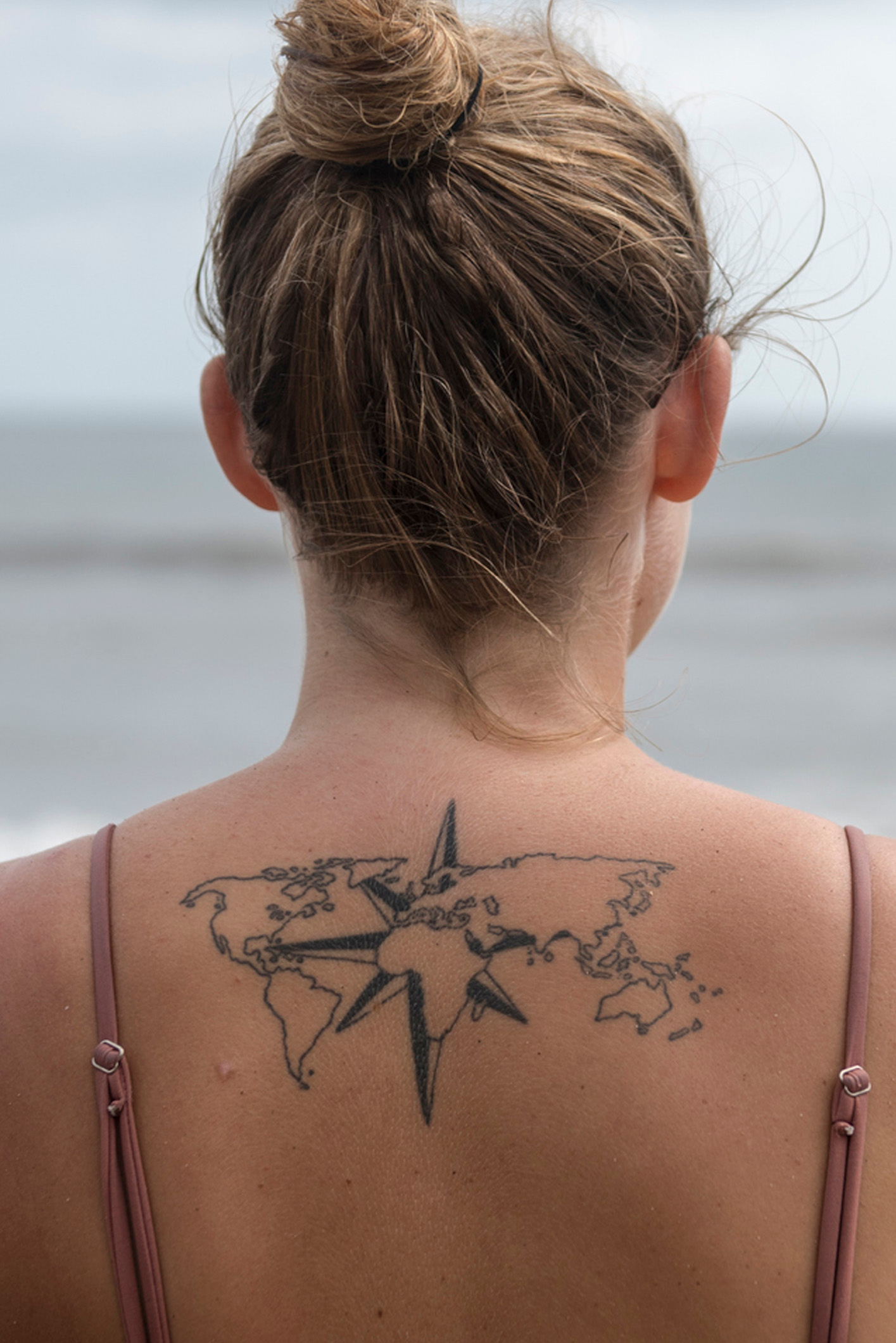 Back tattoo of the world map on Julia Maria del Carmen.