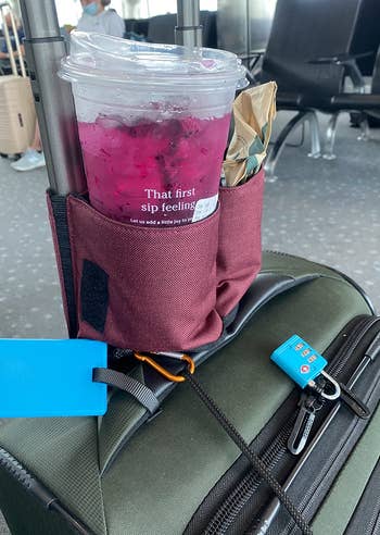 reviewer photo of the red cupholder holding a Starbucks drink in one pocket and a snack in the other pocket