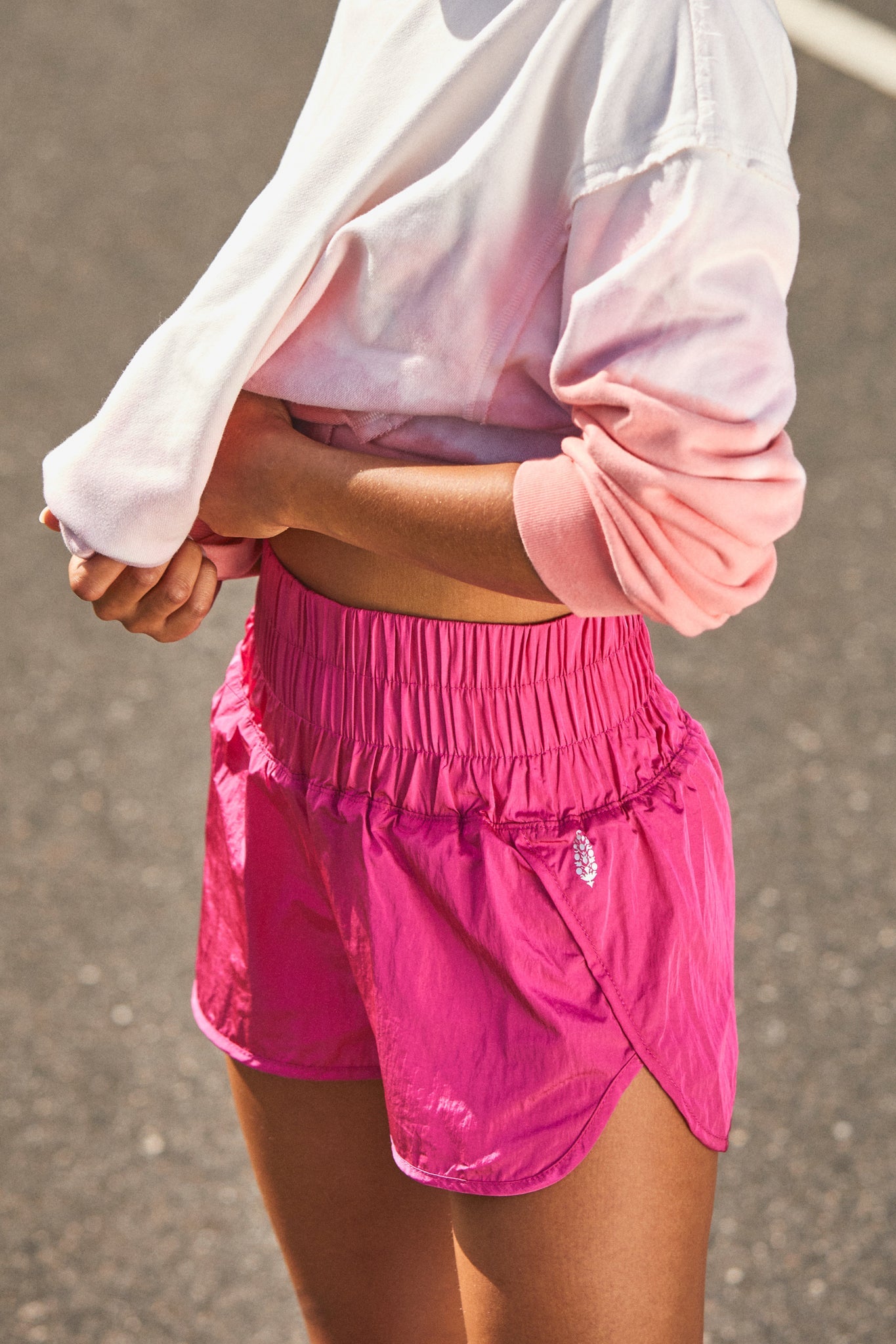 model wearing the high-waisted shorts in bright pink
