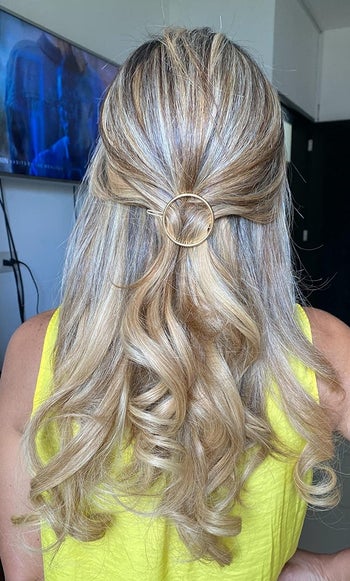 reviewer photo with the gold circle clip at the back of hair