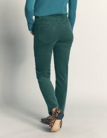Person successful  fitted pants with backmost  pockets, wearing leopard people     shoes, walking away