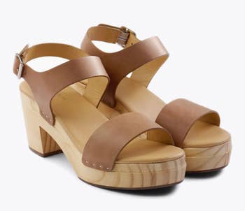 the clogs with a wooden base and brown straps 