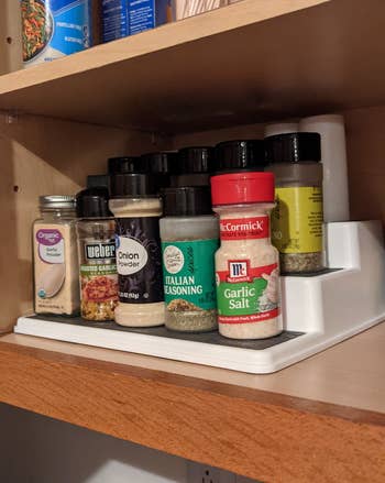 Reviewer photo of spices on tiered organizer shelf
