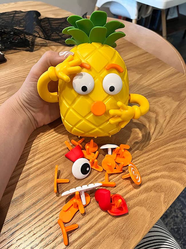 a reviewer photo of the pineapple and the different emotion attachment pieces