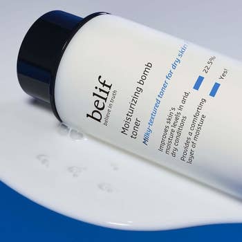 Belif Moisturizing Bomb Toner vessel connected a bedewed bluish and achromatic surface, highlighting benefits for adust tegument and hydration