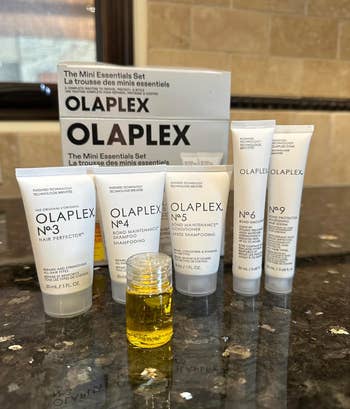 Olaplex Mini Essentials Set with 5  hairsbreadth  attraction   products successful  sleek tubes and a tiny  vessel  of oil, displayed connected  a countertop