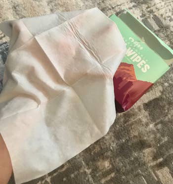 the wipe opened up to show that it's much larger than a hand 