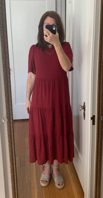 a reviewer wearing the tired midi dress in burgundy 