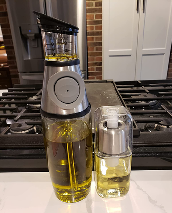 reviewer photo of the oil dispenser and mister on a kitchen counter