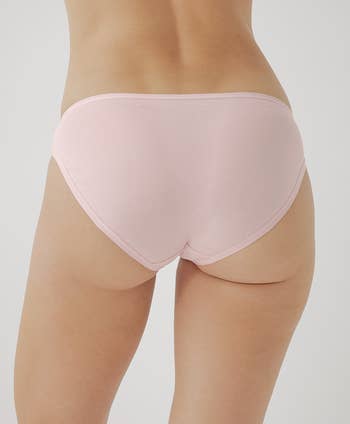 Close-up of a model showing the back of the pink underwear