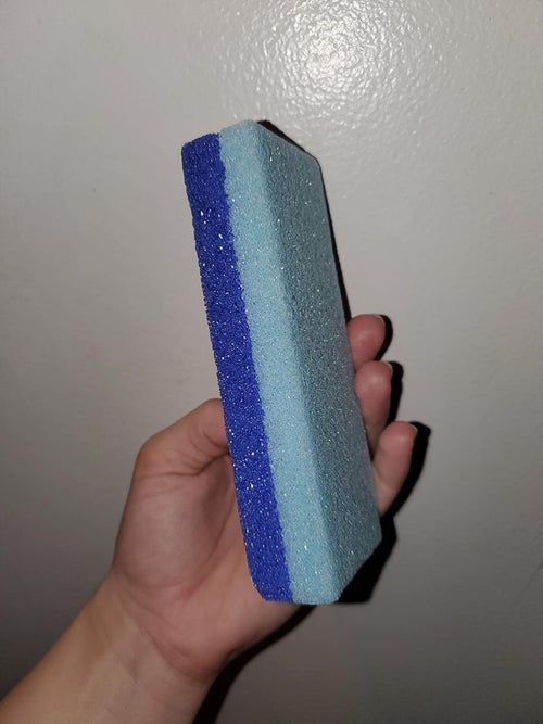 Reviewer holding pumice sponge