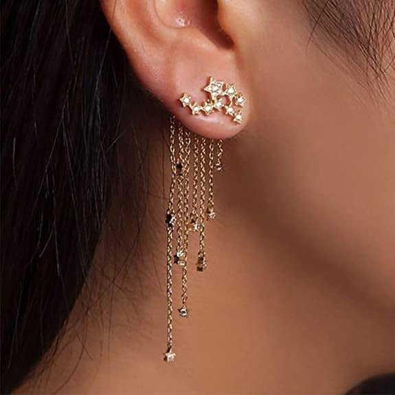 reviewer wearing the gold and rhinestone earrings with constellation shaped studs and backs with chain fringe and matching star charms