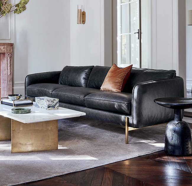 the black leather couch in a living room