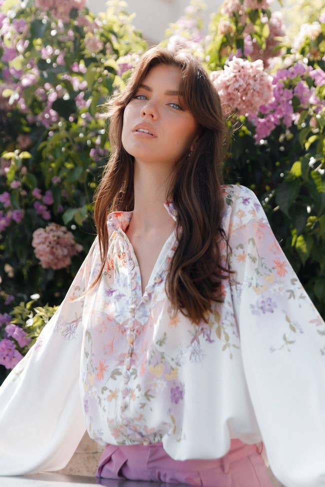 model in the white flowy top with pastel flowers