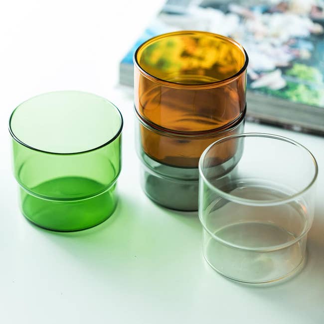 stackable glasses in green, brown, and clear