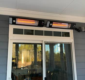 reviewer photo of two heaters above the doors of an outdoor deck