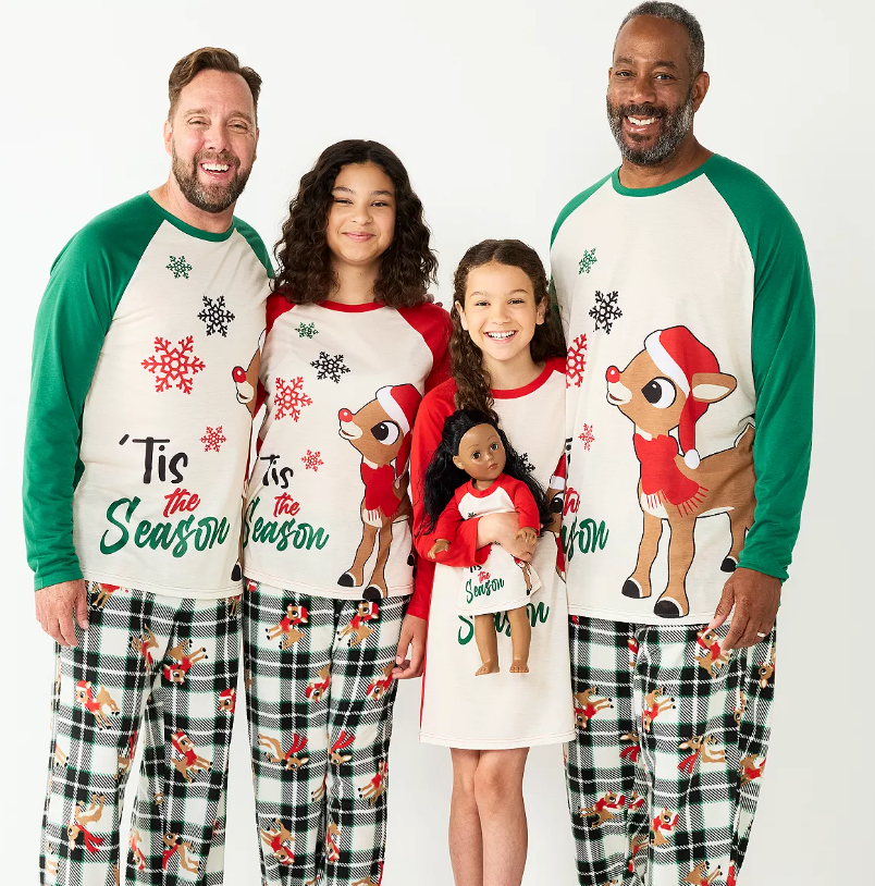 a family in coordinated rudolph pajamas that have rudolph on the shirt and say 