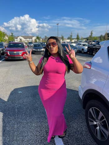 a reviewer wearing the fitted short sleeve maxi dress in hot pink