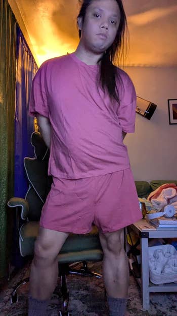 Person successful a casual matching loungewear acceptable stands successful a location mounting with a relaxed posture