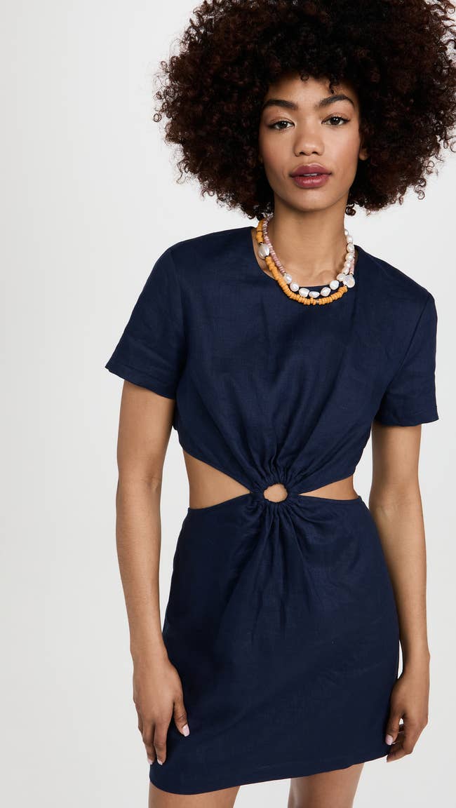 model in navy short sleeve mini with side cutouts