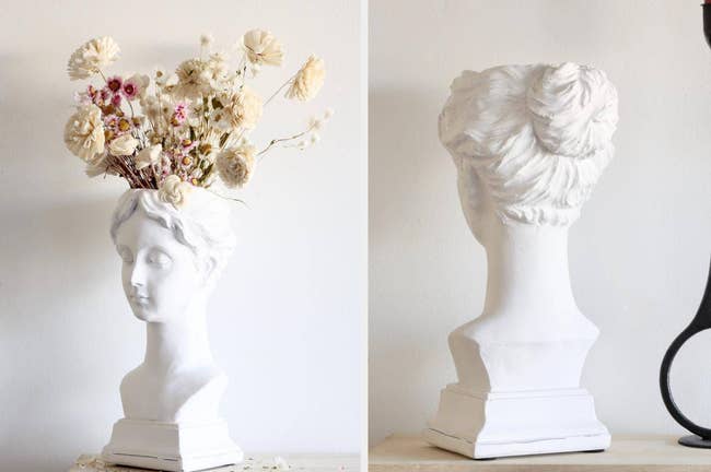 White woman-shaped head bust with dried flowers inside, back view of product on top of a light wooden table