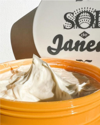 a close up image of the Brazilian bum bum cream that shows the thick, creamy texture