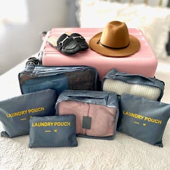 the gray pouches in front of a suitcase