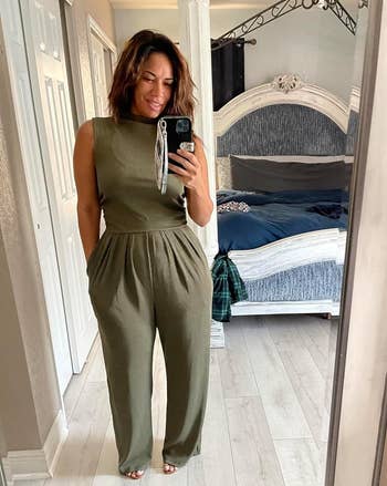 Reviewer wearing a sleeveless jumpsuit with a drawstring waist