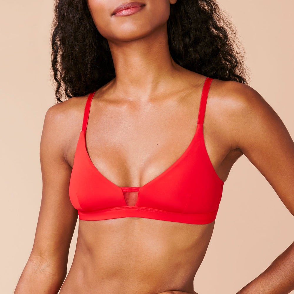 model wearing red scoop bra