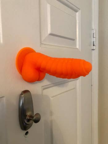 Orange dildo attached to door
