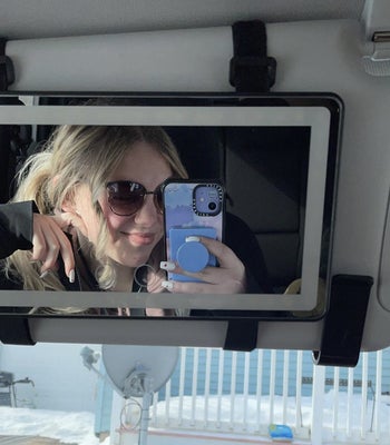 a review photo of someone taking a selfie in the vanity mirror 