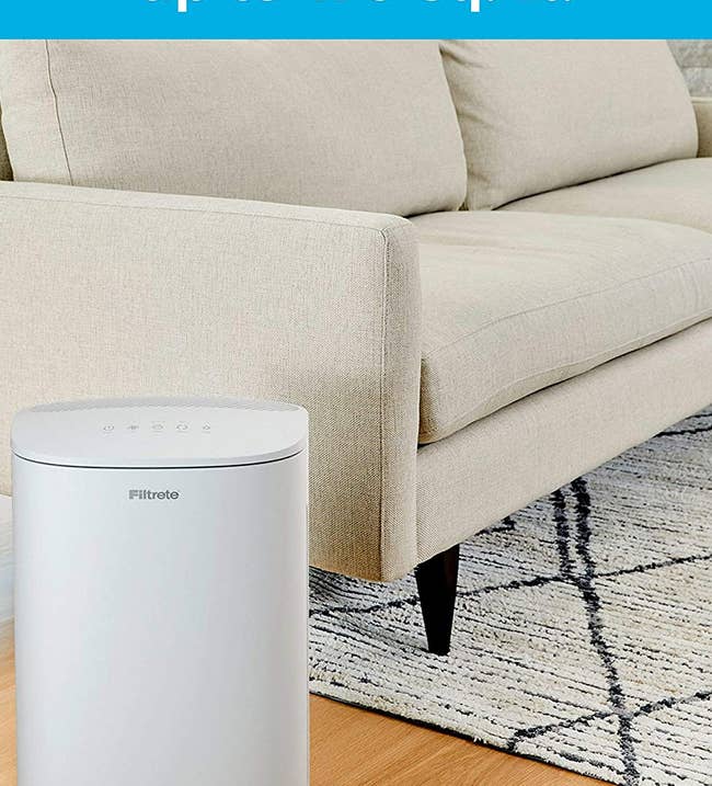 the white air purifier next to a couch