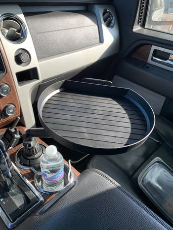 reviewer image of car tray installed in cup holder