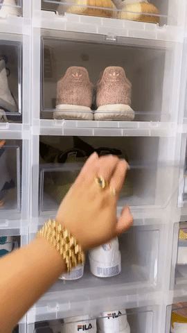 GIF of Buzzfeed writer taking sneakers out from clear box