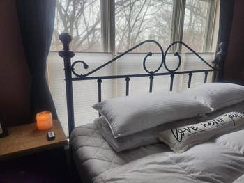 Cozy chamber  with a wrought robust  bed, brushed  pillows, and a 