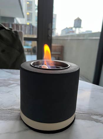 Portable tabletop fireplace with a visible flame